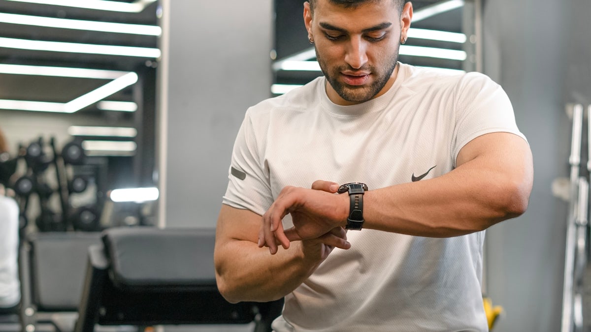 Man checking smartwatch in a gym